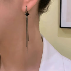 Model showcasing the dangle and style of the 14K Gold-Plated Elegant Black Zircon Diamond Tassel Earrings