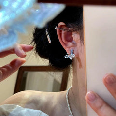 Model showcasing the dangle and style of the 14K Gold-Plated Elegant Blue Crystal Butterfly Stud Earrings