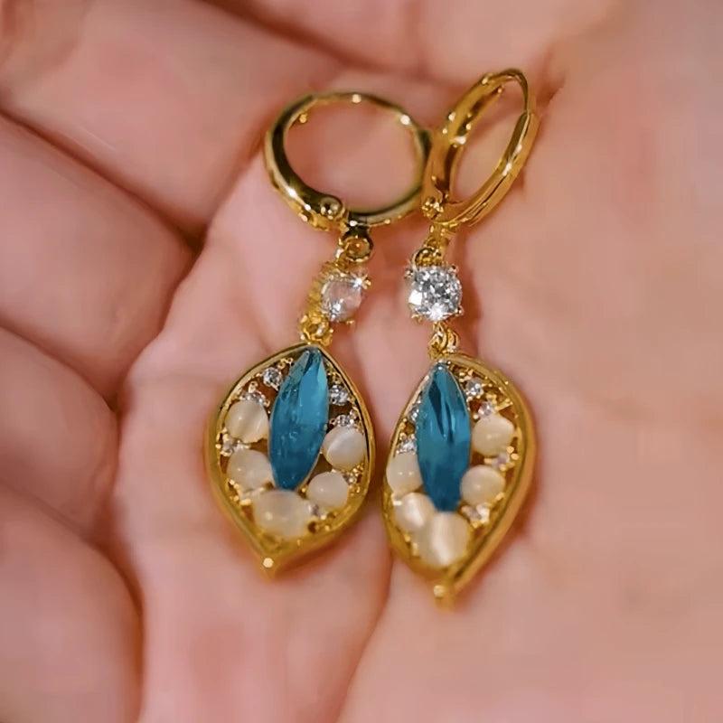 Angled view of the 14K Gold-Plated Elegant Blue Diamond Cat's Eye Stone Leaf Earrings