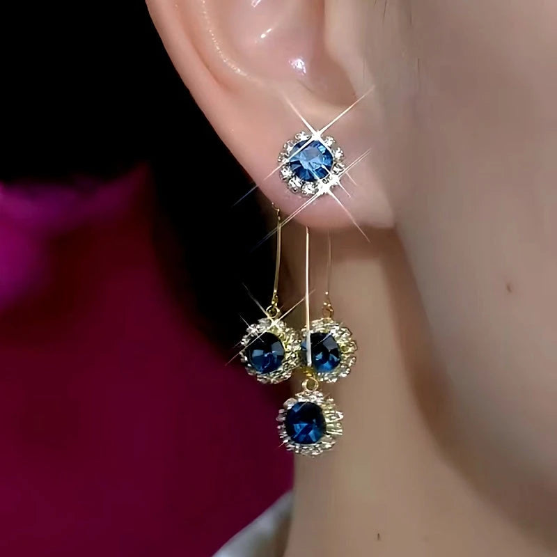 Model showcasing the dangle and style of the 14K Gold-Plated Elegant Blue Zircon Diamond Tassel Earrings