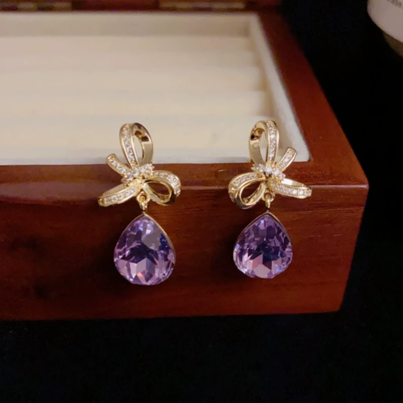 Close-up detail of the sparkling zircons and plating on the Bow Water Drop Earrings