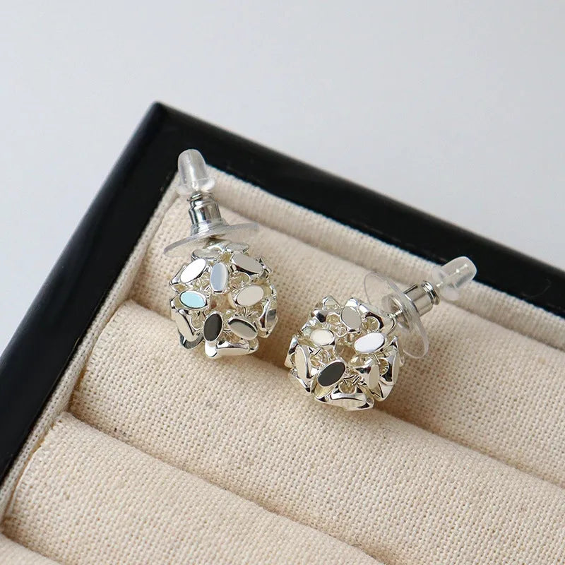 Model showcasing the dangle and style of the 14K Gold-Plated Elegant Broken Ball Stud Earrings