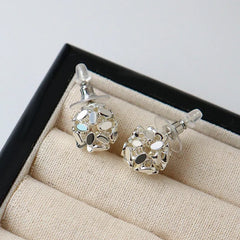 Model showcasing the dangle and style of the 14K Gold-Plated Elegant Broken Ball Stud Earrings