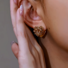 Model showcasing the dangle and style of the 14K Gold-Plated Elegant Brown Diamond Double-Sided Heart Earrings