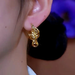 Model showcasing the dangle and style of the 14K Gold-Plated Elegant Brown Diamond Hoop Earrings