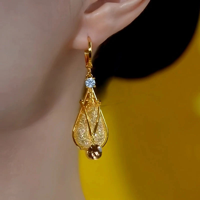 Model showcasing the dangle and style of the 14K Gold-Plated Elegant Brown Diamond Water Drop Earrings
