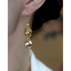 Model showcasing the dangle and style of the 14K Gold-Plated Elegant Brown Zircon Diamond Pearl Threader Earrings
