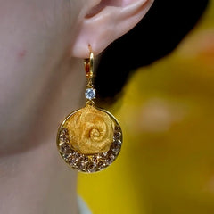 Model showcasing the dangle and style of the 14K Gold-Plated Elegant Brown Zircon Diamond Rose Earrings