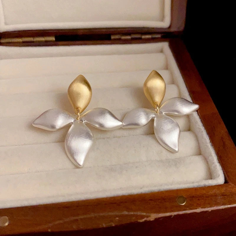 Angled view of the 14K Gold-Plated Elegant Brushed Gold And Silver Contrast Leaf Earrings