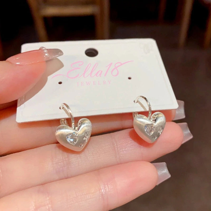 Angled view of the 14K Gold-Plated Elegant Brushed Heart Earrings