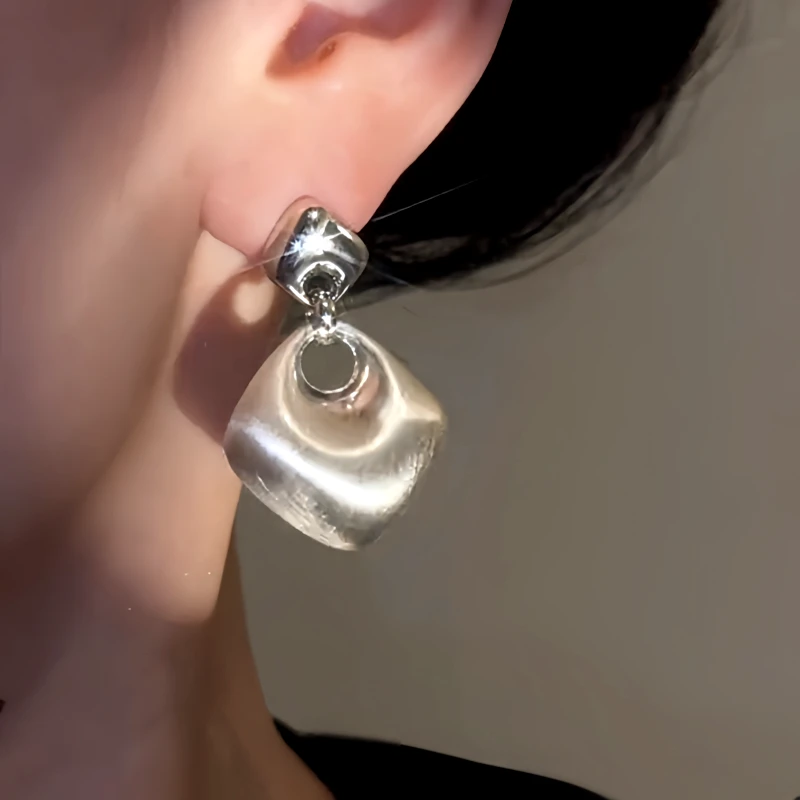 Close-up detail of the sparkling zircons and plating on the Brushed Water Drop Earrings