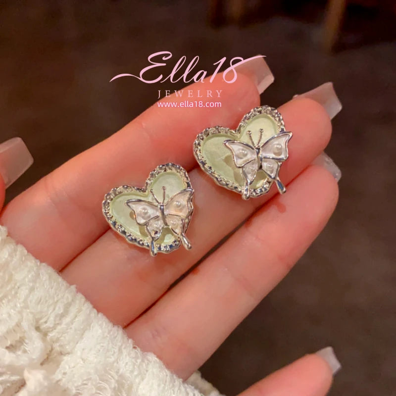 Model showcasing the dangle and style of the 14K Gold-Plated Elegant Butterfly Heart Earrings