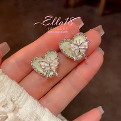 Model showcasing the dangle and style of the 14K Gold-Plated Elegant Butterfly Heart Earrings