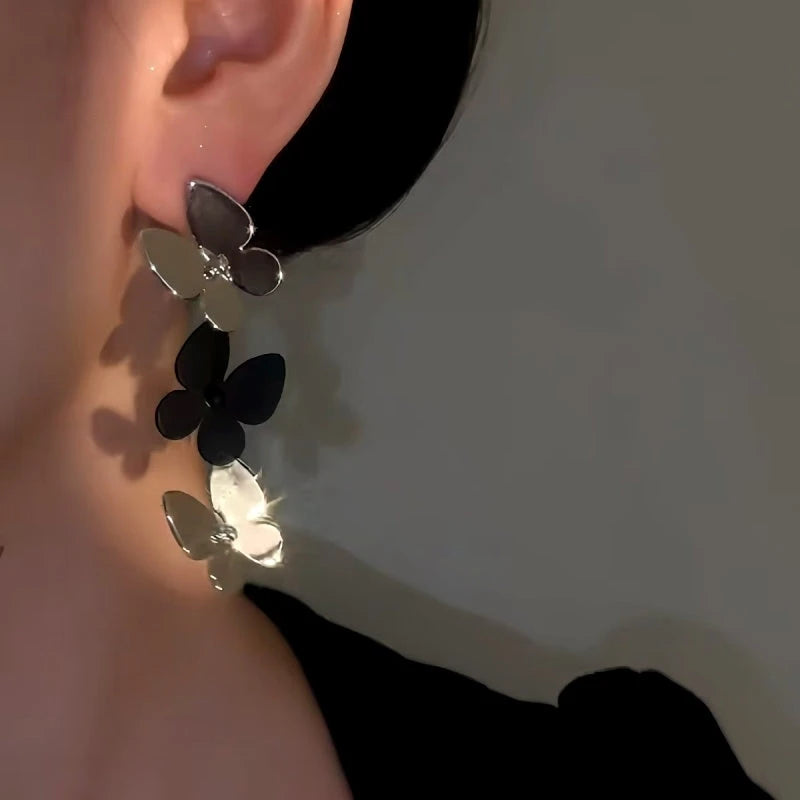 Model showcasing the dangle and style of the 14K Gold-Plated Elegant Butterfly Tassel Earrings