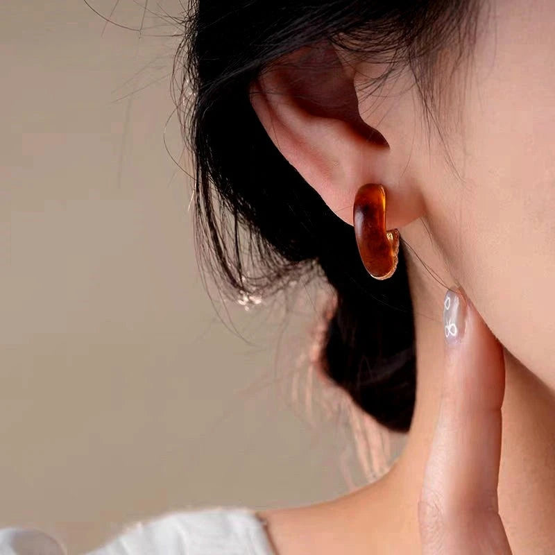 Model showcasing the dangle and style of the 14K Gold-Plated Elegant C-Ring Earrings