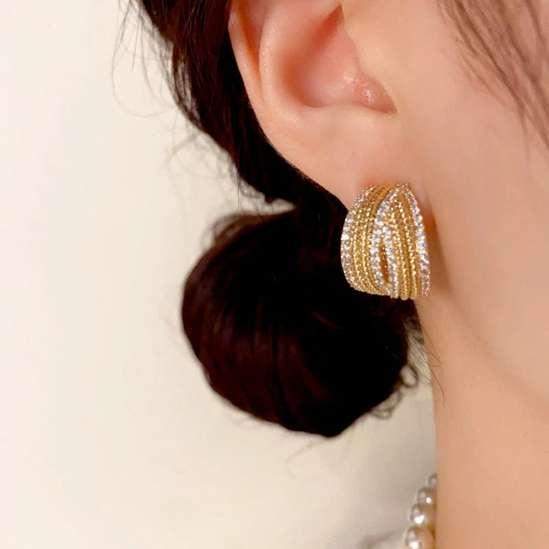 Model showcasing the dangle and style of the 14K Gold-Plated Elegant C-Shaped Diamond Earrings