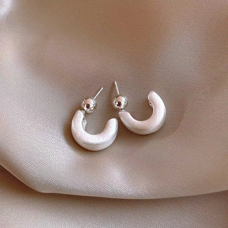 Angled view of the 14K Gold-Plated Elegant C-Shaped Earrings