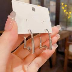 Angled view of the 14K Gold-Plated Elegant C-Shaped Earrings