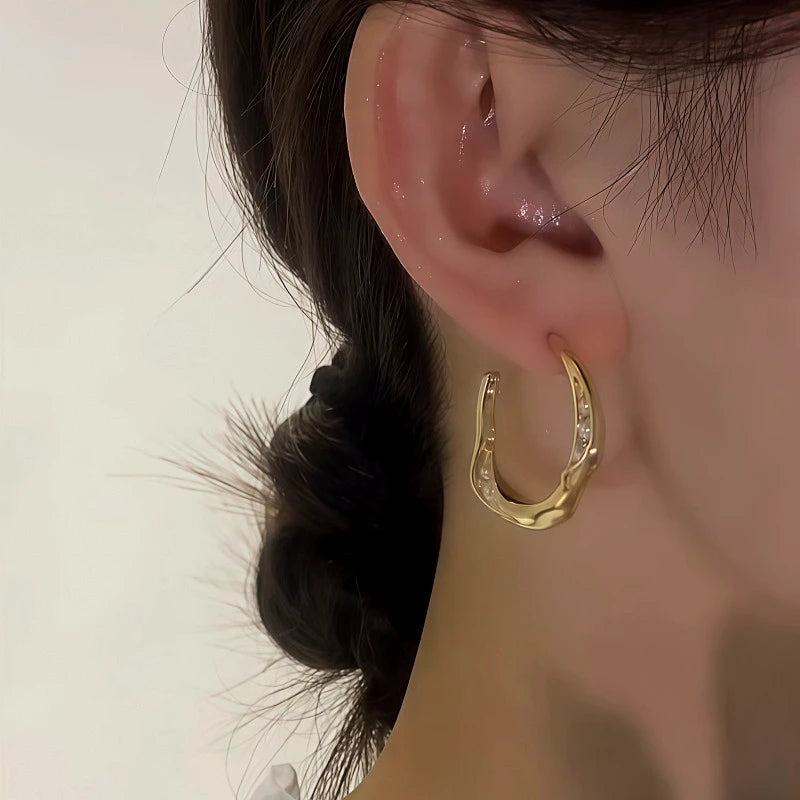 Close-up detail of the sparkling zircons and plating on the C-Shaped Pearl Earrings