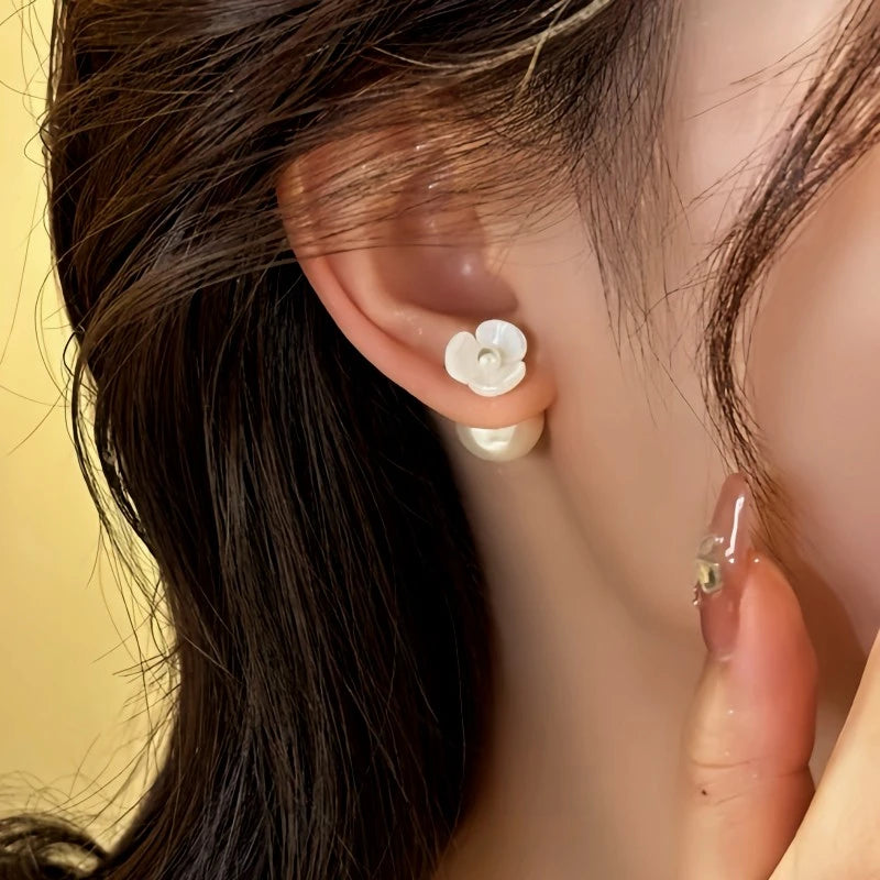 Close-up detail of the sparkling zircons and plating on the Camellia Ear Jackets