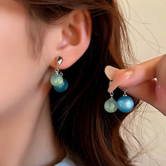 Close-up detail of the sparkling zircons and plating on the Cross Earrings