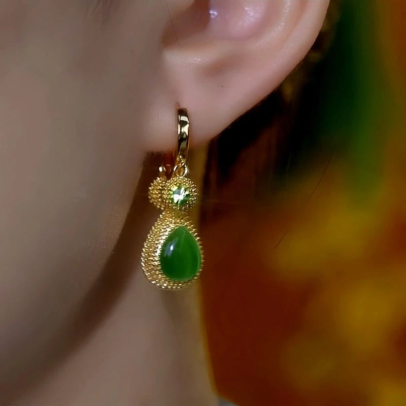 Close-up detail of the sparkling zircons and plating on the Green Statement Earrings