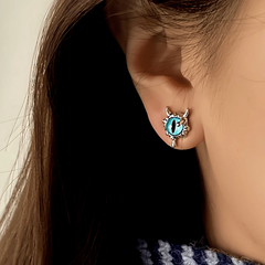 Close-up detail of the sparkling zircons and plating on the Devil Stud Earrings