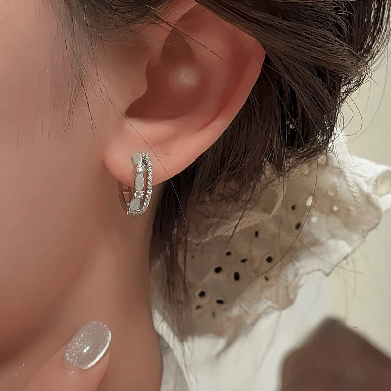 Model showcasing the dangle and style of the 14K Gold-Plated Elegant Cat's Eye Stone Double-Layer Hoop Earrings