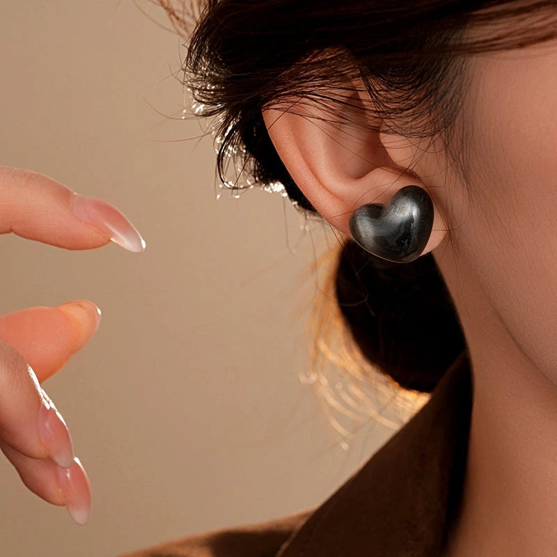 Model showcasing the dangle and style of the 14K Gold-Plated Elegant Cat's Eye Stone Stud Earrings