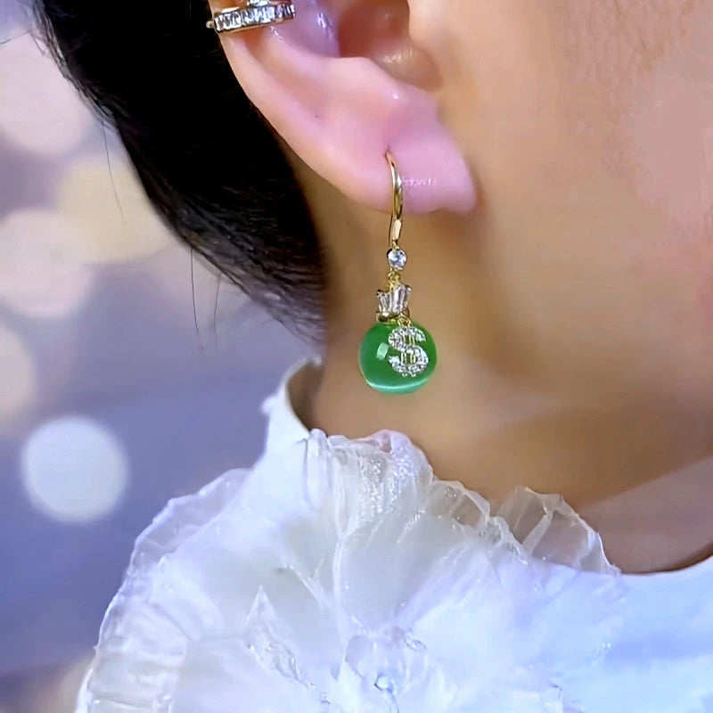 Model showcasing the dangle and style of the 14K Gold-Plated Elegant Cat's Eye $ Earrings