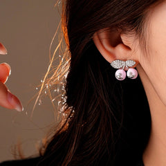 Model showcasing the dangle and style of the 14K Gold-Plated Elegant Cherry Saturn Earrings