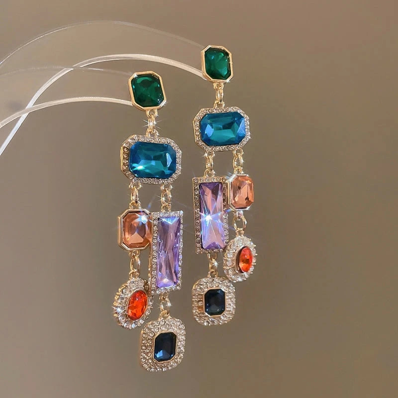 Model showcasing the dangle and style of the 14K Gold-Plated Elegant Colorful Diamond Tassel Earrings