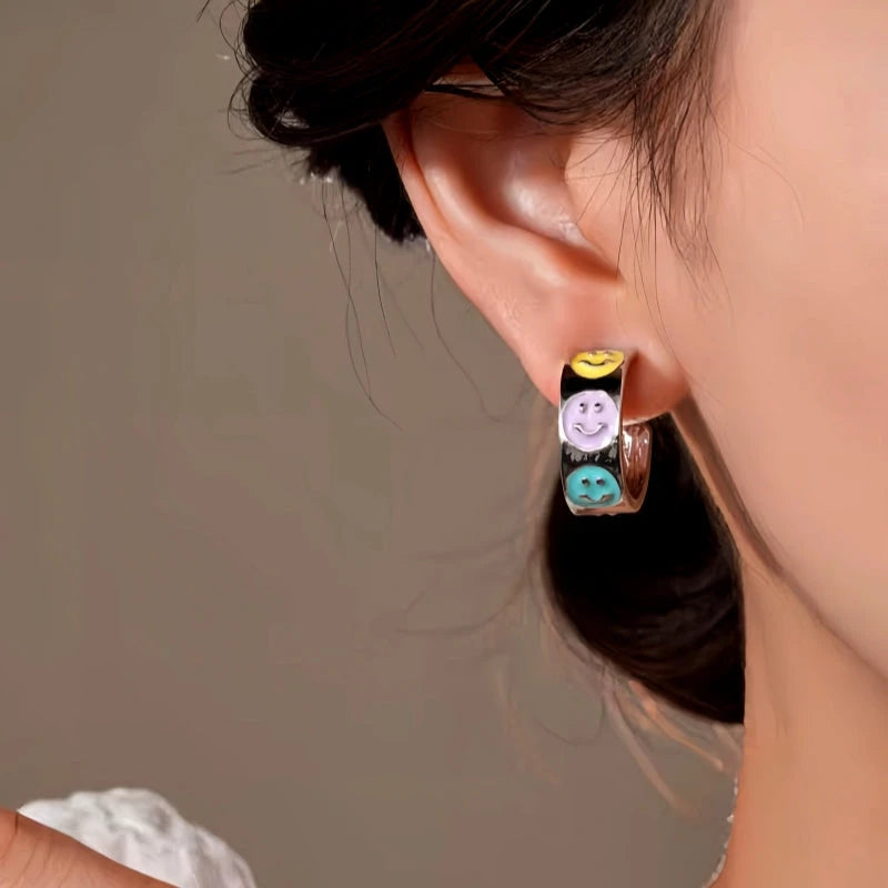 Close-up detail of the sparkling zircons and plating on the Smile Face Earrings