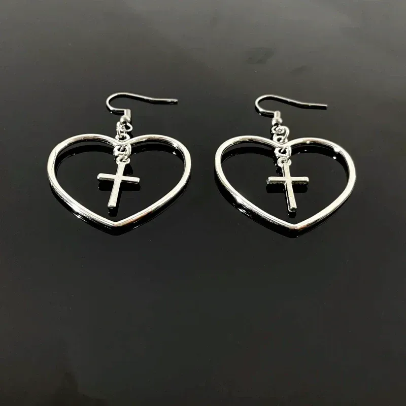 Model showcasing the dangle and style of the 14K Gold-Plated Elegant Cross Heart Ear Hook Earrings