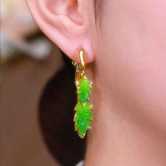 Angled view of the 14K Gold-Plated Elegant Crystal Leaf Cross Earrings