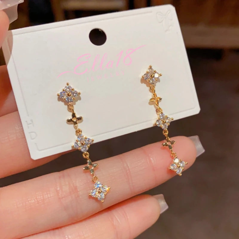 Model showcasing the dangle and style of the 14K Gold-Plated Elegant Diamond-Filled Long Tassel Earrings