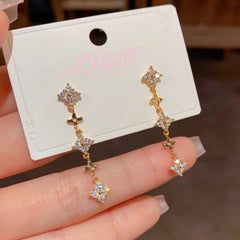 Model showcasing the dangle and style of the 14K Gold-Plated Elegant Diamond-Filled Long Tassel Earrings