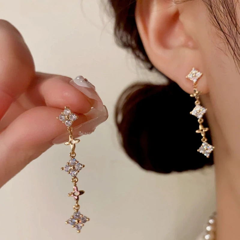 Angled view of the 14K Gold-Plated Elegant Diamond-Filled Long Tassel Earrings