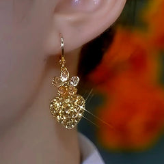 Close-up detail of the sparkling zircons and plating on the Flower Heart Earrings