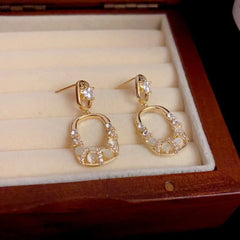 Model showcasing the dangle and style of the 14K Gold-Plated Elegant Diamond Geometric Square Earrings
