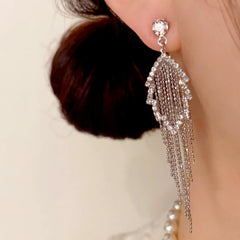 Model showcasing the dangle and style of the 14K Gold-Plated Elegant Diamond Hollow Leaf Tassel Earrings