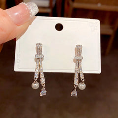 Angled view of the 14K Gold-Plated Elegant Diamond Knotted Water Drop Earrings