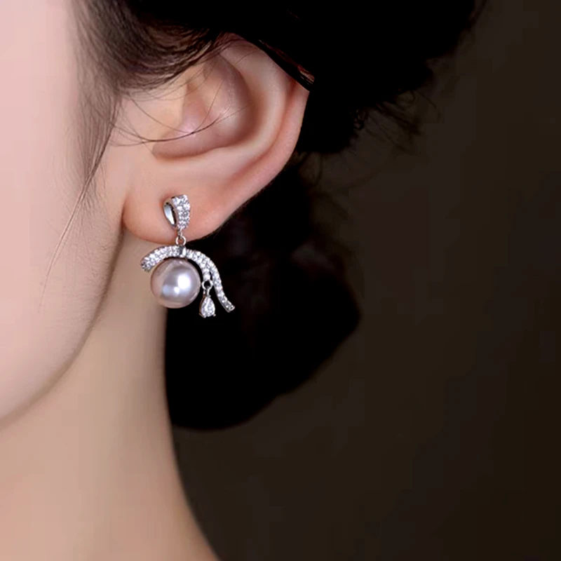 Close-up detail of the sparkling zircons and plating on the Ribbon Pearl Earrings