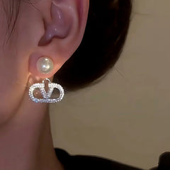 Close-up detail of the sparkling zircons and plating on the V Letter Pearl Earrings