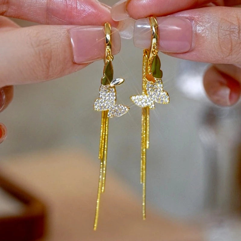 Angled view of the 14K Gold-Plated Elegant Double-Butterfly Tassel Earrings