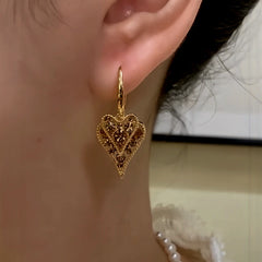 Close-up detail of the sparkling zircons and plating on the Heart Tassel Earrings