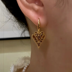 Model showcasing the dangle and style of the 14K Gold-Plated Elegant Double-Layer Brown Zircon Heart Tassel Earrings
