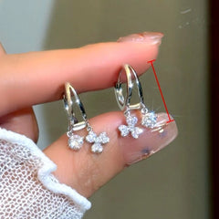 Angled view of the 14K Gold-Plated Elegant Double-Layer Flashing leaf Tassel Earrings