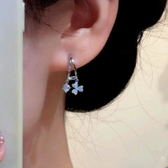 Model showcasing the dangle and style of the 14K Gold-Plated Elegant Double-Layer Flashing leaf Tassel Earrings