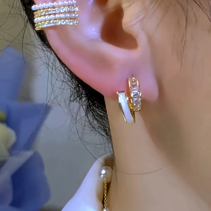 Model showcasing the dangle and style of the 14K Gold-Plated Elegant Double-Layer Shell Zircon Hoop Earrings